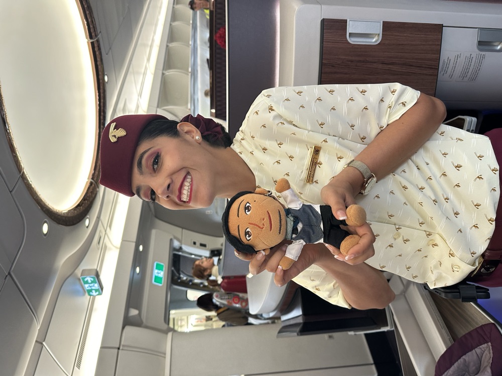 飛行機の機内でCAさんに抱っこされるじぶんぐるみ